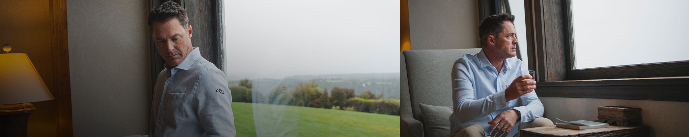 A man wearing a KJUS Inverness Shirt steps inside a pair of large glass doors from an outdoor area filled with vegetation.